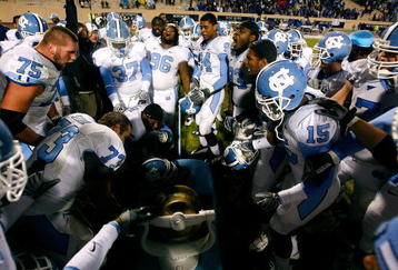 DURHAM, NC - NOVEMBER 29:  The North Carolina Tar Heels cheer as they ring the Victory Bell after defeating the Duke Blue Devils 28-20 at Wallace Wade Stadium on November 29, 2008 in Durham, North Carolina.  (Photo by Kevin C. Cox/Getty Images)