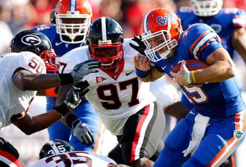 JACKSONVILLE, FL - OCTOBER 31:  Quarterback Tim Tebow #15 of the Florida Gators rushes upfield against Rennie Curran #35, Darryl Gamble #50 and Brandon Wood #97 of the Georgia Bulldogs at Jacksonville Municipal Stadium on October 31, 2009 in Jacksonville, Florida.  (Photo by Kevin C. Cox/Getty Images)