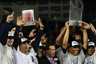 NEW YORK - NOVEMBER 04:  (L-R) A.J. Burnett #34, Jorge Posada #20, Derek Jeter #2, Mariano Rivera #42 (holding trophy) Robinson Cano #24 and Nick Swisher #33 of the New York Yankees against the Philadelphia Phillies in Game Six of the 2009 MLB World Series at Yankee Stadium on November 4, 2009 in the Bronx borough of New York City.  (Photo by Chris McGrath/Getty Images)