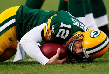 GREEN BAY, WI - NOVEMBER 01:  Quarterback Aaron Rodgers #12 of the Green Bay Packers is sacked during the third quarter of the game against the Minnesota Vikings at Lambeau Field on November 1, 2009 in Green Bay, Wisconsin. (Photo by Scott Boehm/Getty Images)
