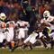 SAN DIEGO, CA - DECEMBER 30:   Runningback LeGarrette Blount #9 of the University of Oregon Ducks hurdles a player en route to a touchdown during his team's 42-31 win over the Oklahoma State University Cowboys in the Pacific Life Holiday Bowl at Qualcomm Stadium on December 30, 2008 in San Diego, California. (Photo by Donald Miralle/Getty Images)