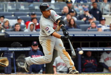 NEW YORK - MAY 17:  Carlos Gomez #22 of the Minnesota Twins connects for a eigth inning base hit against the New York Yankees on May 17, 2009 at Yankee Stadium in the Bronx borough of New York City.  (Photo by Jim McIsaac/Getty Images)