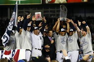 NEW YORK - NOVEMBER 04:  (L-R) A.J. Burnett #34, Jorge Posada #20, Derek Jeter #2, Mariano Rivera #42 (holding trophy) Robinson Cano #24 and Nick Swisher #33 of the New York Yankees against the Philadelphia Phillies in Game Six of the 2009 MLB World Series at Yankee Stadium on November 4, 2009 in the Bronx borough of New York City.  (Photo by Chris McGrath/Getty Images)