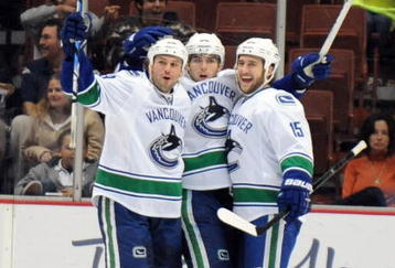 ANAHEIM, CA - OCTOBER 30:  Steve Bernier #18 of the Vancouver Canucks celebrates his goal for a 1-0 lead with Tanner Glass #15 and Aaron Rome #29 against the Anaheim Ducks during the first period at the Honda Center on October 30, 2009 in Anaheim, California.  (Photo by Harry How/Getty Images)