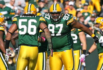 GREEN BAY, WI - OCTOBER 18: Johnny Jolly #97 and  Nick Barnett #56 of the Green Bay Packers celebrate a defensive stop against the Detroit Lions at Lambeau Field on October 18, 2009 in Green Bay, Wisconsin. The Packers defeated the Lions 26-0. (Photo by Jonathan Daniel/Getty Images)