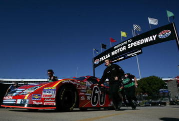 FORT WORTH, TX - NOVEMBER 06:  Crew members push the #60 Ortho Ford driven by Carl Edwards, through the garage area during practice for the NASCAR Nationwide Series O'Reilly Challenge at Texas Motor Speedway on November 6, 2009 in Fort Worth, Texas.  (Photo by Darrell Ingham/Getty Images)