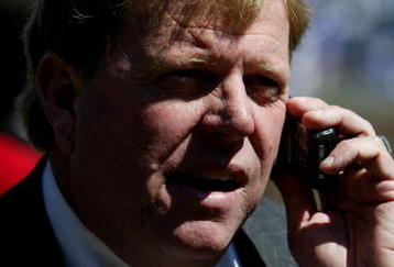 CHICAGO - APRIL 8:  General Manager Jim Hendry of the Chicago Cubs works the phone before the Opening Day game between the Cubs and the Milwaukee Brewers on April 8, 2005 at Wrigley Field in Chicago, Illinois.  (Photo by Jonathan Daniel/Getty Images)