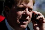 CHICAGO - APRIL 8:  General Manager Jim Hendry of the Chicago Cubs works the phone before the Opening Day game between the Cubs and the Milwaukee Brewers on April 8, 2005 at Wrigley Field in Chicago, Illinois.  (Photo by Jonathan Daniel/Getty Images)