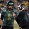 EUGENE, OR - OCTOBER 31: Quarterback Jeremiah Masoli #8 and speaks with head coach Chip Kelly of the Oregon Ducks during a timeout in the third quarter of the game against the USC Trojans at Autzen Stadium on October 31, 2009 in Eugene, Oregon. Masoli threw for 222 yards and a touchdown and ran for 164 more yards with another score as Oregon defeated USC 47-20. (Photo by Steve Dykes/Getty Images)