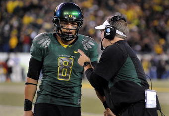 EUGENE, OR - OCTOBER 31: Quarterback Jeremiah Masoli #8 and speaks with head coach Chip Kelly of the Oregon Ducks during a timeout in the third quarter of the game against the USC Trojans at Autzen Stadium on October 31, 2009 in Eugene, Oregon. Masoli threw for 222 yards and a touchdown and ran for 164 more yards with another score as Oregon defeated USC 47-20. (Photo by Steve Dykes/Getty Images)