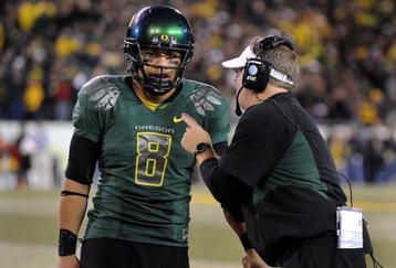EUGENE, OR - OCTOBER 31: Quarterback Jeremiah Masoli #8 and speaks with head coach Chip Kelly of the Oregon Ducks during a timeout in the third quarter of the game against the USC Trojans at Autzen Stadium on October 31, 2009 in Eugene, Oregon. Masoli threw for 222 yards and a touchdown and ran for 164 more yards with another score as Oregon defeated USC 47-20. (Photo by Steve Dykes/Getty Images)