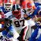 JACKSONVILLE, FL - OCTOBER 31:  Quarterback Tim Tebow #15 of the Florida Gators rushes upfield against Rennie Curran #35, Darryl Gamble #50 and Brandon Wood #97 of the Georgia Bulldogs at Jacksonville Municipal Stadium on October 31, 2009 in Jacksonville, Florida.  (Photo by Kevin C. Cox/Getty Images)