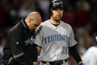 BOSTON - SEPTEMBER 29:  Adam Lind #26 of the Toronto Blue Jays is looked after by a member of the medical staff after he was hit by a pitch in the ninth inning against the Boston Red Sox on September 29, 2009 at Fenway Park in Boston, Massachusetts. The Blue Jays defeated the Red Sox 8-7.  (Photo by Elsa/Getty Images)