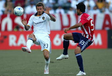 CARSON, CA - NOVEMBER 01:  David Beckham #23 of the Los Angeles Galaxy pressures the play of Marcelo Saragosa #55 of Chivas USA in the first half during Game 1 of the MLS Western Conference Semifinals match at The Home Depot Center on November 1, 2009 in Carson, California.  The Galaxy and Chivas USA played to a 2-2 draw. (Photo by Victor Decolongon/Getty Images)
