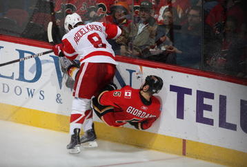 CALGARY, CANADA - OCTOBER 31:   Justin Abdelkader #8 of the Detroit Red Wings checks Mark Giordano #5 the Calgary Flames on October 31st, 2009 at the Pengrowth Saddledome in Calgary, Alberta, Canada. (Photo by Dale MacMillan/Getty Images)