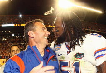 MIAMI - JANUARY 08:  Head coach Urban Meyer of the Florida Gators celebrates with Brandon Spikes #51 their win over the Oklahoma Sooners after the FedEx BCS National Championship Game at Dolphin Stadium on January 8, 2009 in Miami, Florida.  (Photo by Donald Miralle/Getty Images)