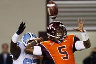 BLACKSBURG, VA - OCTOBER 29:  Quarterback Tyrod Taylor #5 of the Virginia Tech University Hokies is defended by E.J. Wilson #92 of the North Carolina Tar Heels during the  game at Lane Stadium on October 29, 2009 in Blacksburg, Virginia.  (Photo by Scott Halleran/Getty Images)