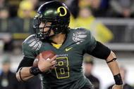 EUGENE, OR - OCTOBER 31: Quarterback Jeremiah Masoli #8 of the Oregon Ducks runs with the ball in the second quarter of the game against the USC Trojans at Autzen Stadium on October 31, 2009 in Eugene, Oregon. Masoli threw for 222 yards and a touchdown and ran for 164 more yards with another score as Oregon defeated USC 47-20. (Photo by Steve Dykes/Getty Images)