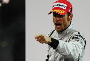 ABU DHABI, UNITED ARAB EMIRATES - NOVEMBER 01:  Jenson Button of Great Britain and Brawn GP celebrates on the podium after finishing third during the Abu Dhabi Formula One Grand Prix at the Yas Marina Circuit on November 1, 2009 in Abu Dhabi, United Arab Emirates.  (Photo by Mark Thompson/Getty Images)