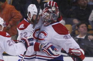 BOSTON - NOVEMBER 05:  Carey Price #31 of the Montreal Canadiens is congratulated by teammates Paul Mara #22 and Josh Gorges #26 the Boston Bruins on November 5, 2009 at the TD Garden in Boston, Massachusetts. The Canadiens defeated the Bruins 2-1 in an overtime shootout.  (Photo by Elsa/Getty Images)