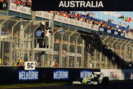 MELBOURNE, AUSTRALIA - MARCH 29: Jenson Button of Great Britain and Brawn GP takes the chequered flag as he crosses the finish line to win the Australian Formula One Grand Prix at the Albert Park Circuit on March 29, 2009 in Melbourne, Australia. (Photo by Robert Cianflone/Getty Images)