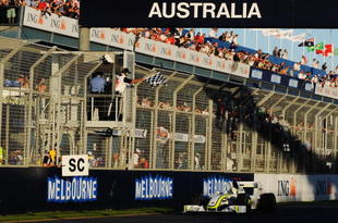 MELBOURNE, AUSTRALIA - MARCH 29: Jenson Button of Great Britain and Brawn GP takes the chequered flag as he crosses the finish line to win the Australian Formula One Grand Prix at the Albert Park Circuit on March 29, 2009 in Melbourne, Australia. (Photo by Robert Cianflone/Getty Images)