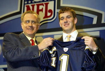 NEW YORK - APRIL 24:  Eli Manning receives a San Diego Chargers jersey from NFL Commissioner Paul Tagliabue during the 2004 NFL Draft on April 24, 2004 at Madison Square Garden in New York City. Manning was selected first pick overall by the San Diego Chargers then traded to the New York Giants for Philip Rivers and 3 draft picks.  (Photo by Chris Trotman/Getty Images)