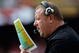 KANSAS CITY, MO - SEPTEMBER 20:  Head coach Tom Cable of the Oakland Raiders calls plays from the bench during the game against the Kansas City Chiefs at Arrowhead Stadium on September 20, 2009 in Kansas City, Missouri.  (Photo by Jamie Squire/Getty Images)