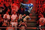 LAS VEGAS - AUGUST 24:  Wrestler Evan Bourne jumps off the ropes at wrestler Chavo Guerrero (C) as wrestler Hornswoggle lies in the foreground during the WWE Monday Night Raw show at the Thomas & Mack Center August 24, 2009 in Las Vegas, Nevada.  (Photo by Ethan Miller/Getty Images)