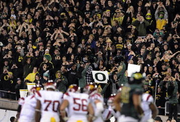 EUGENE, OR - OCTOBER 31: Oregon Duck fans stand up and cheer as the USC Trojans huddle in the third quarter of the game at Autzen Stadium on October 31, 2009 in Eugene, Oregon. The Ducks upset the Trojans 47-20. (Photo by Steve Dykes/Getty Images)