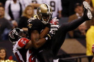 NEW ORLEANS - NOVEMBER 2:  Marques Colston #12 of the New Orleans Saints catches a pass for a touchdown against Tye Hill #24 of the Atlanta Falcons during the second quarter of the game at the Louisiana Superdome on November 2, 2009 in New Orleans, Louisiana. (Photo by Chris Graythen/Getty Images)