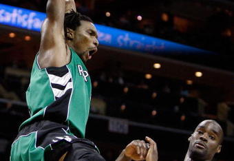 CHARLOTTE, NC - MARCH 16:  Chris Bosh #4 of the Toronto Raptors reacts after a dunk against Emeka Okafor #50 of the Charlotte Bobcats during their game at Time Warner Cable Arena on March 16, 2009 in Charlotte, North Carolina.  NOTE TO USER: User expressly acknowledges and agrees that, by downloading and/or using this Photograph, user is consenting to the terms and conditions of the Getty Images License Agreement.  (Photo by Streeter Lecka/Getty Images)