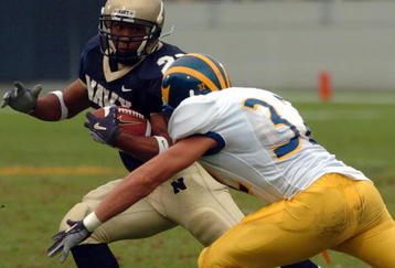 ANNAPOLIS, MD - OCTOBER 30:  In this handout from the U.S. Navy, Delaware Blue Hen's defensive back Kyle Campbell #32 tries to block U.S. Naval Academy Midshipman 3rd Class Trey Hines on a rushing attempt in the 2nd quarter on October 30, 2004 at Navy-Marine Corps Memorial Stadium in Annapolis, Maryland.  (Photo by Damon J. Moritz/US Navy via Getty Images)