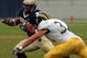 ANNAPOLIS, MD - OCTOBER 30:  In this handout from the U.S. Navy, Delaware Blue Hen's defensive back Kyle Campbell #32 tries to block U.S. Naval Academy Midshipman 3rd Class Trey Hines on a rushing attempt in the 2nd quarter on October 30, 2004 at Navy-Marine Corps Memorial Stadium in Annapolis, Maryland.  (Photo by Damon J. Moritz/US Navy via Getty Images)