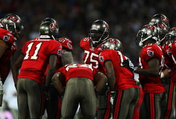 LONDON, ENGLAND - OCTOBER 25: The Tampa Bay Buccaneers offense in discussion during the NFL International Series match between New England Patriots and Tampa Bay Buccaneers at Wembley Stadium on October 25, 2009 in London, England. This is the third occasion where a regular season NFL match has been played in London.  (Photo by Julian Finney/Getty Images)