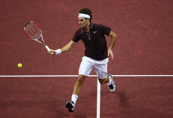BASEL, SWITZERLAND - NOVEMBER 07:  Roger Federer of Switzerland plays a volley in his match against Marco Chiudinelli of Switzerland during Day Six of the Davidoff Swiss Indoors Tennis at St Jakobshalle on November 7, 2009 in Basel, Switzerland.  (Photo by Julian Finney/Getty Images)