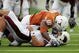 AUSTIN, TX - SEPTEMBER 5:  Defensive end Sam Acho #81 of the Texas Longhorns falls on quarterback Trey Revell #12 of the Louisiana Monroe Warhawks after knocking the ball away from Revell during their game on September 5, 2009 at Darrell K Royal-Texas Memorial Stadium in Austin, Texas. The Longhorns defeated the Warhawks 59-20. (Photo by Brian Bahr/Getty Images)