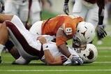 AUSTIN, TX - SEPTEMBER 5:  Defensive end Sam Acho #81 of the Texas Longhorns falls on quarterback Trey Revell #12 of the Louisiana Monroe Warhawks after knocking the ball away from Revell during their game on September 5, 2009 at Darrell K Royal-Texas Memorial Stadium in Austin, Texas. The Longhorns defeated the Warhawks 59-20. (Photo by Brian Bahr/Getty Images)