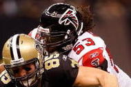 NEW ORLEANS - NOVEMBER 02: David Thomas #85 of the New Orleans Saints runs for a first down against Erik Coleman #26 and Mike Peterson #53 of the Atlanta Falcons during the first quarter of the game at the Louisiana Superdome on November 2, 2009 in New Orleans, Louisiana. (Photo by Chris Graythen/Getty Images)