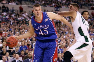 INDIANAPOLIS - MARCH 27:  Cole Aldrich #45 of the Kansas Jayhawks drives against Goran Suton #14 of the Michigan State Spartans during the third round of the NCAA Division I Men's Basketball Tournament at the Lucas Oil Stadium on March 27, 2009 in Indianapolis, Indiana.  (Photo by Andy Lyons/Getty Images)