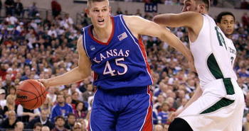 INDIANAPOLIS - MARCH 27:  Cole Aldrich #45 of the Kansas Jayhawks drives against Goran Suton #14 of the Michigan State Spartans during the third round of the NCAA Division I Men's Basketball Tournament at the Lucas Oil Stadium on March 27, 2009 in Indianapolis, Indiana.  (Photo by Andy Lyons/Getty Images)