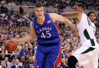 INDIANAPOLIS - MARCH 27:  Cole Aldrich #45 of the Kansas Jayhawks drives against Goran Suton #14 of the Michigan State Spartans during the third round of the NCAA Division I Men's Basketball Tournament at the Lucas Oil Stadium on March 27, 2009 in Indianapolis, Indiana.  (Photo by Andy Lyons/Getty Images)