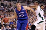 INDIANAPOLIS - MARCH 27:  Cole Aldrich #45 of the Kansas Jayhawks drives against Goran Suton #14 of the Michigan State Spartans during the third round of the NCAA Division I Men's Basketball Tournament at the Lucas Oil Stadium on March 27, 2009 in Indianapolis, Indiana.  (Photo by Andy Lyons/Getty Images)