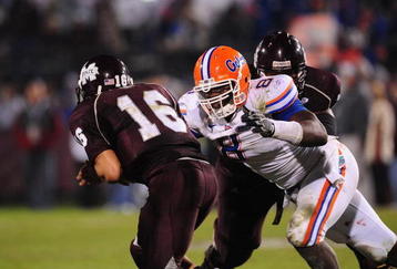 STARKVILLE, MS - OCTOBER 24:  Quarterback Tyson Lee # 16 of the Mississippi State Bulldogs is tackled by defensive end Carlos Dunlap # 8 of the Florida Gators, at Davis Wade Stadium on  October 24, 2009 in Starkville, Mississippi  (Photo by Rick Dole/Getty Images)