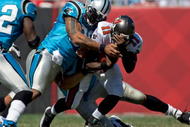 TAMPA, FL - OCTOBER 18:  Defensive end Julius Peppers #90 of the Carolina Panthers tackles quarterback Josh Johnson #11 of the Tampa Bay Buccaneers during the game at Raymond James Stadium on October 18, 2009 in Tampa, Florida.  (Photo by J. Meric/Getty Images)