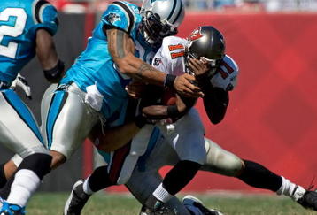 TAMPA, FL - OCTOBER 18:  Defensive end Julius Peppers #90 of the Carolina Panthers tackles quarterback Josh Johnson #11 of the Tampa Bay Buccaneers during the game at Raymond James Stadium on October 18, 2009 in Tampa, Florida.  (Photo by J. Meric/Getty Images)