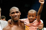 LAS VEGAS - APRIL 11:  Paul Williams holds his son Paul Williams Jr. as he celebrates defeating Winky Wright in a unanimous decision in their middleweight bout at the Mandalay Bay Events Center April 11, 2009 in Las Vegas, Nevada.  (Photo by Ethan Miller/Getty Images)