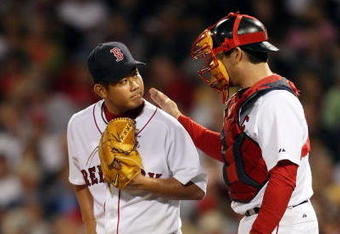 BOSTON - SEPTEMBER 15:  Daisuke Matsuzaka #18 and Jason Varitek #33 of the Boston Red Sox talk in between pitches in the fifth inning against the Los Angeles Angels of Anaheim on September 15, 2009 at Fenway Park in Boston, Massachusetts. The Red Sox defeated the Rays 3-1.  (Photo by Elsa/Getty Images)