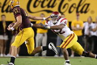 TEMPE, AZ - NOVEMBER 07:  Quarterback Brock Osweiler #17 of the Arizona State Sun Devils scrambles with the ball past Devon Kennard #42 of the USC Trojans during the college football game at Sun Devil Stadium on November 7, 2009 in Tempe, Arizona.  The Trojans defeated the Devils 14-9.  (Photo by Christian Petersen/Getty Images)