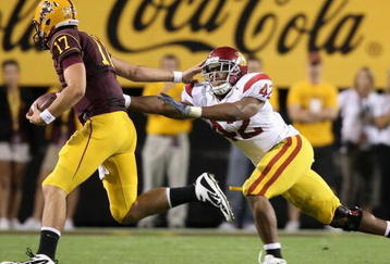 TEMPE, AZ - NOVEMBER 07:  Quarterback Brock Osweiler #17 of the Arizona State Sun Devils scrambles with the ball past Devon Kennard #42 of the USC Trojans during the college football game at Sun Devil Stadium on November 7, 2009 in Tempe, Arizona.  The Trojans defeated the Devils 14-9.  (Photo by Christian Petersen/Getty Images)